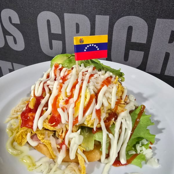 Arepa cabimera mixta with shredded beef and chicken, cheese and salad.